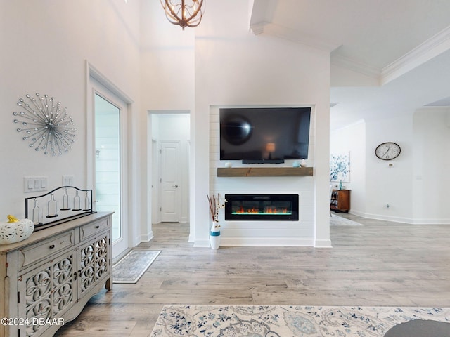 living room featuring ornamental molding, high vaulted ceiling, and light hardwood / wood-style flooring