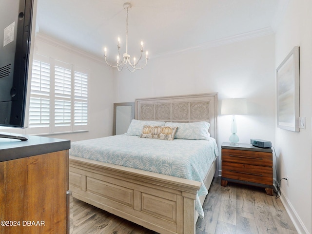 bedroom featuring a notable chandelier, wood-type flooring, and ornamental molding