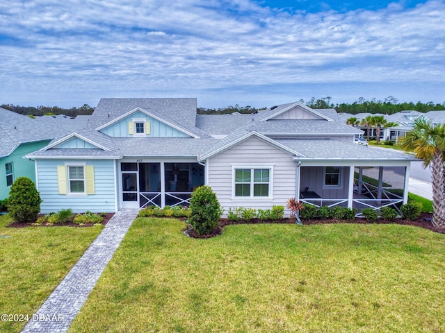 view of front of house with a front lawn and a sunroom