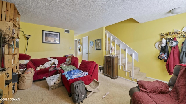 living area featuring stairs, a textured ceiling, carpet flooring, and visible vents