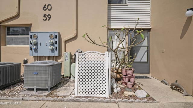 details featuring stucco siding and central AC