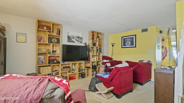 living area with carpet flooring, a textured ceiling, and visible vents
