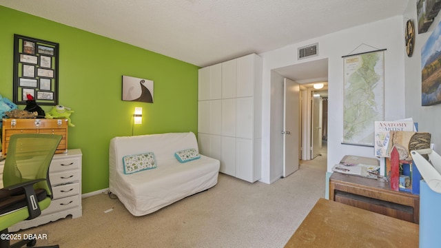 sitting room featuring visible vents and light colored carpet
