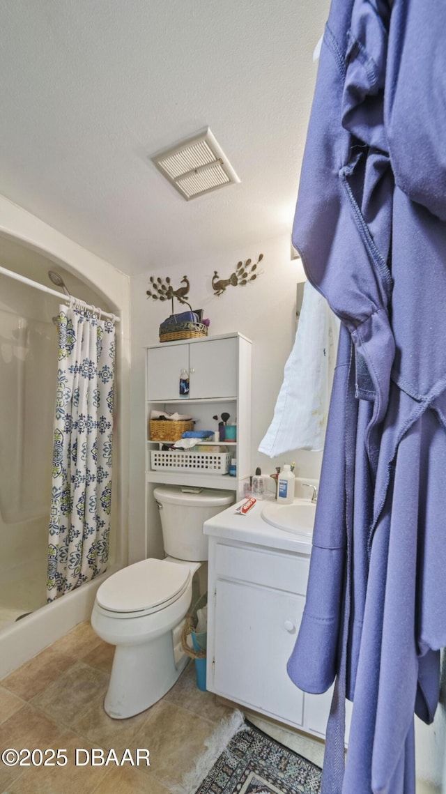 full bath with toilet, visible vents, a shower stall, and vanity