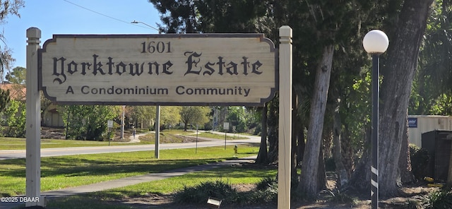 community / neighborhood sign with a lawn