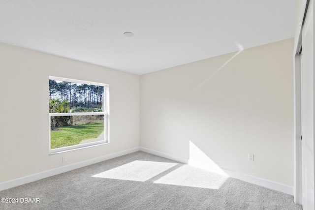 empty room with carpet flooring and baseboards