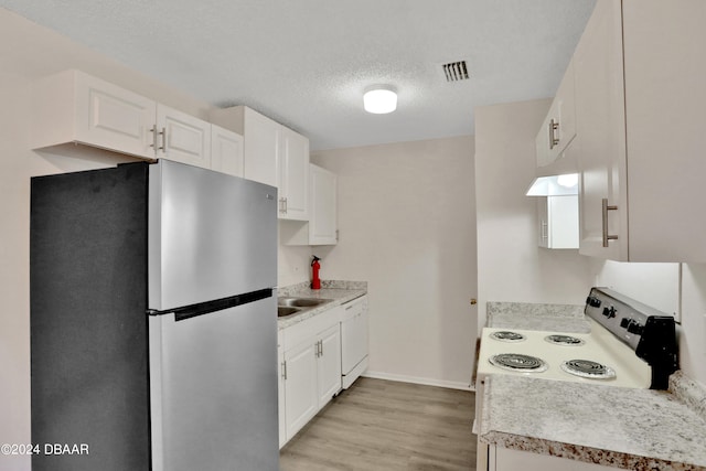 kitchen featuring white cabinetry, light hardwood / wood-style floors, and white appliances