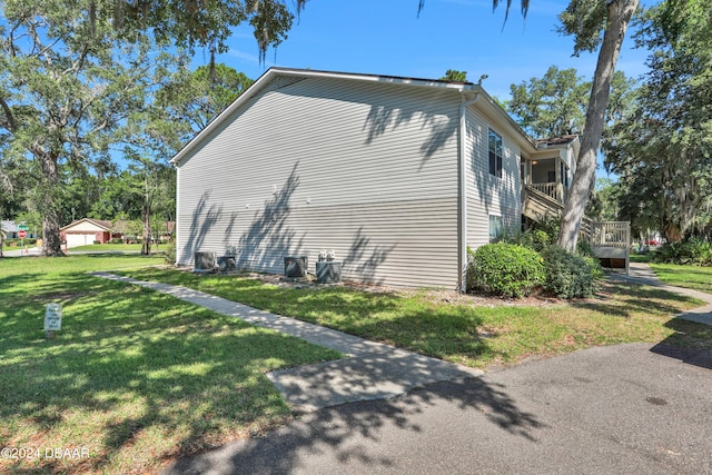 view of home's exterior with a lawn