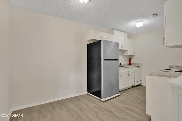 kitchen with light hardwood / wood-style floors, stainless steel refrigerator, a textured ceiling, white cabinets, and dishwasher