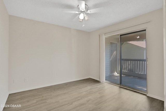 unfurnished room featuring ceiling fan, wood-type flooring, and a textured ceiling