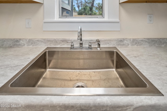 room details with white cabinetry and sink