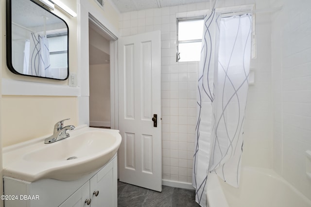 bathroom featuring vanity and shower / bath combination with curtain