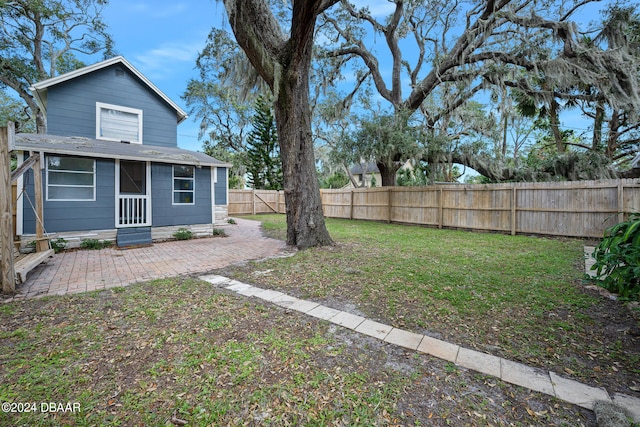 view of yard featuring an outdoor structure and a patio