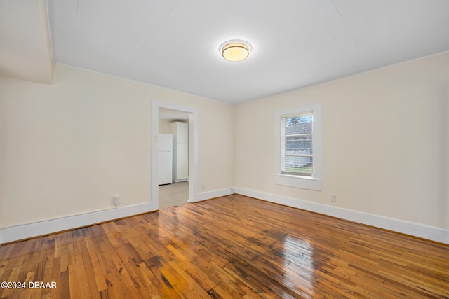 spare room with hardwood / wood-style floors