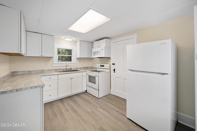 kitchen featuring white cabinetry, white appliances, sink, and light hardwood / wood-style floors