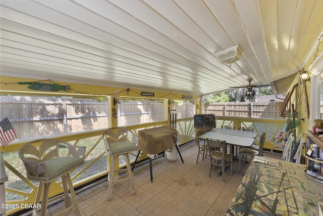 sunroom featuring wood ceiling