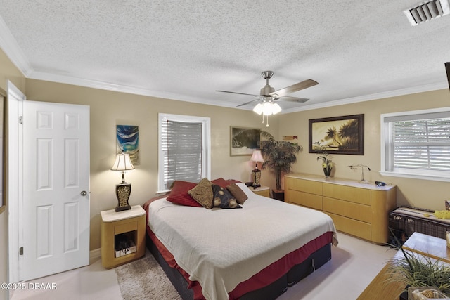 bedroom with visible vents, ceiling fan, light colored carpet, ornamental molding, and a textured ceiling