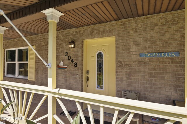 entrance to property with brick siding