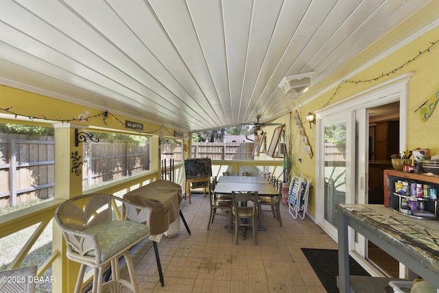 sunroom / solarium featuring wood ceiling