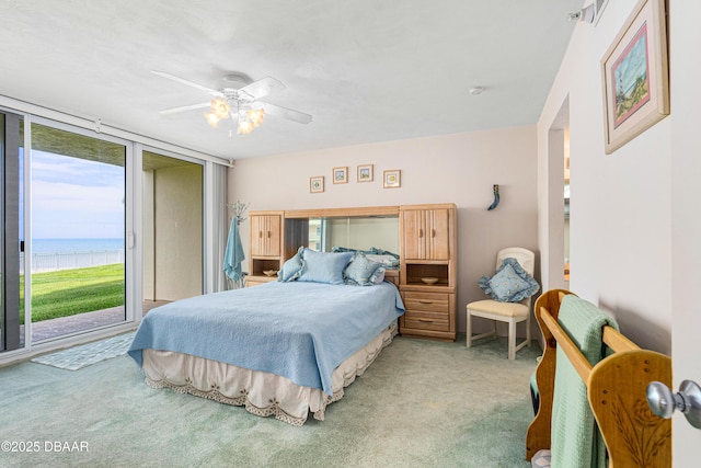 2545 S Atlantic Ave Unit 0102, Daytona Beach Shores, FL 32118 - bedroom featuring carpet, access to outside, a water view, and a ceiling fan