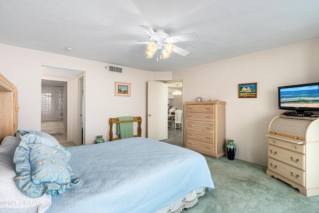 2545 S Atlantic Ave Unit 0102, Daytona Beach Shores, FL 32118 - bedroom featuring light colored carpet, ceiling fan, and ensuite bath