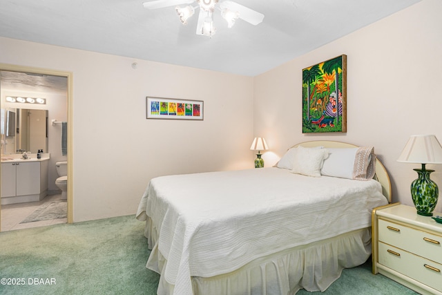 2545 S Atlantic Ave Unit 0102, Daytona Beach Shores, FL 32118 - bedroom with light carpet, ensuite bathroom, and ceiling fan