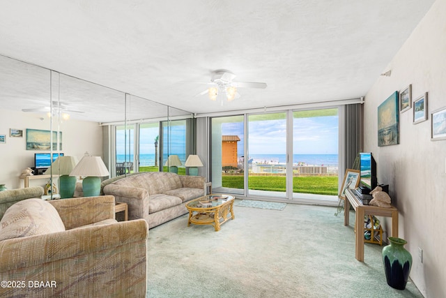 2545 S Atlantic Ave Unit 0102, Daytona Beach Shores, FL 32118 - living area with ceiling fan, carpet, floor to ceiling windows, and a textured ceiling