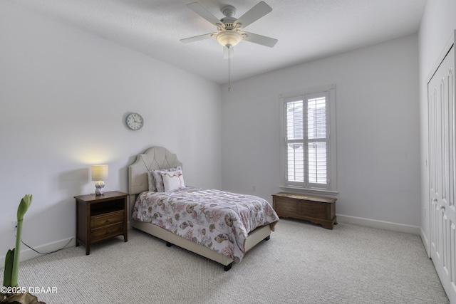 carpeted bedroom featuring a closet and ceiling fan