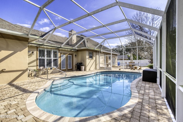 view of swimming pool with area for grilling, central AC, a patio, and glass enclosure