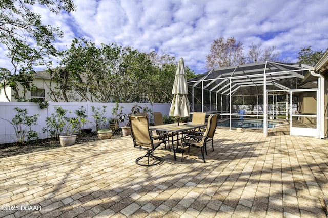 view of patio featuring a fenced in pool and glass enclosure