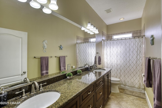 full bathroom featuring tile patterned floors, toilet, shower / tub combo, a textured ceiling, and vanity