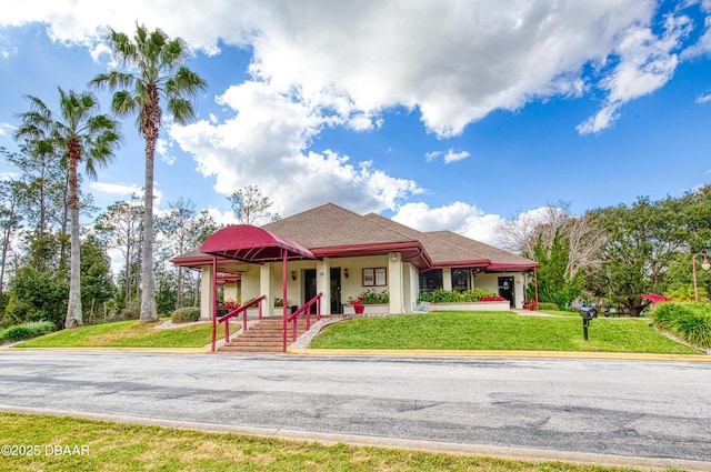 view of front of house with a front yard and a porch