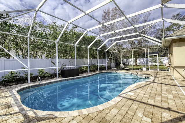 view of swimming pool with a patio and glass enclosure