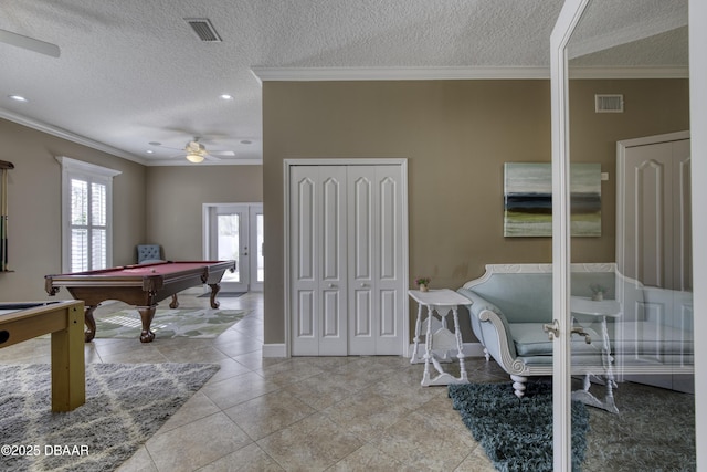 playroom featuring crown molding, billiards, a textured ceiling, and light tile patterned floors