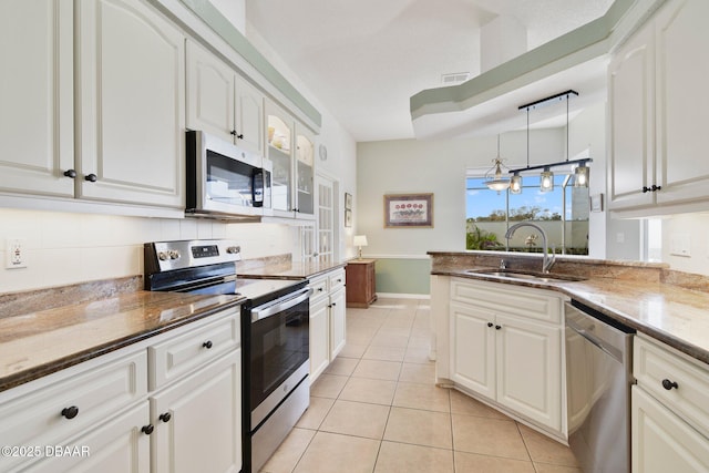 kitchen featuring stainless steel appliances and white cabinets