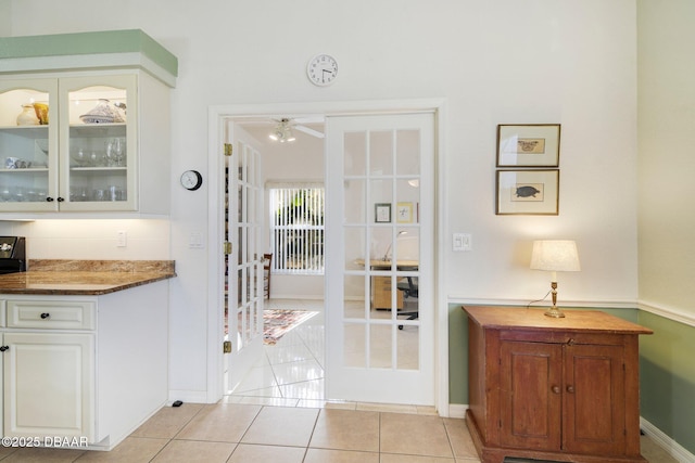 doorway to outside with light tile patterned flooring and french doors