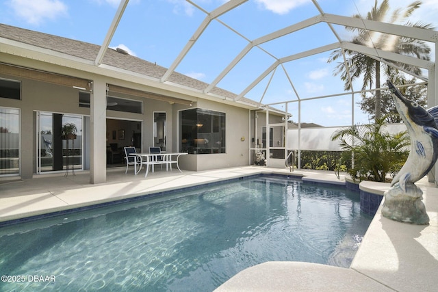 view of pool featuring a patio and glass enclosure