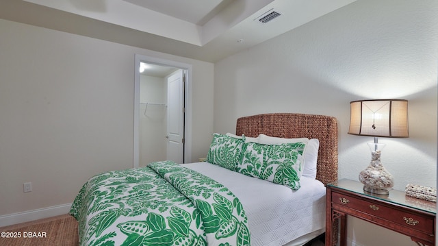 bedroom with carpet, a closet, and a walk in closet