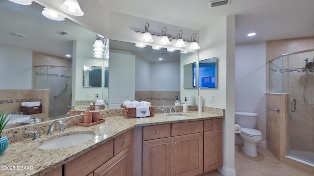 bathroom with a shower with door, toilet, tile patterned floors, and vanity