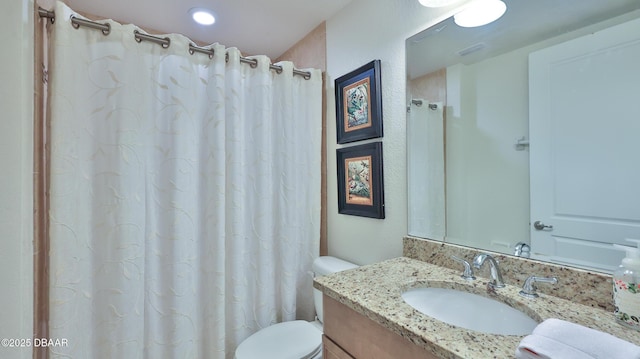 bathroom with toilet and vanity