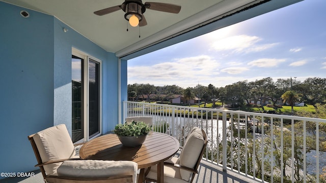 balcony with a water view and ceiling fan