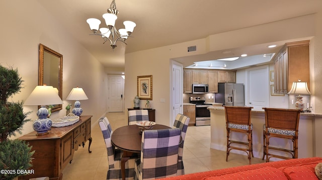 dining room with a notable chandelier and light tile patterned flooring