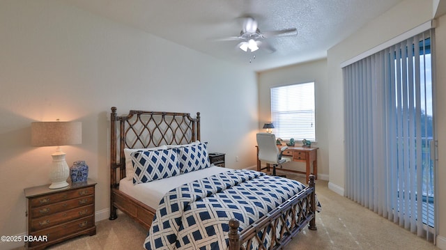 bedroom featuring ceiling fan, carpet, and a textured ceiling