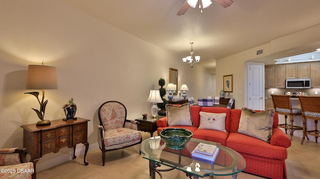 living room with ceiling fan with notable chandelier