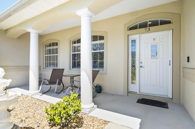 73 Foxhall Ln, Palm Coast, FL 32137 - entrance to property with covered porch and stucco siding