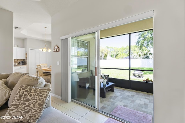73 Foxhall Ln, Palm Coast, FL 32137 - living area with a chandelier, light tile patterned floors, and baseboards