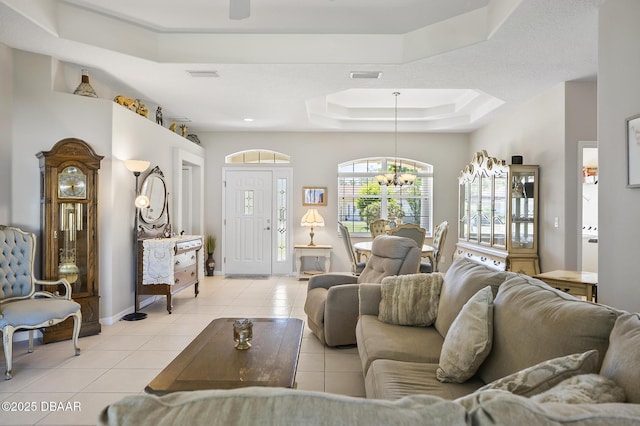 73 Foxhall Ln, Palm Coast, FL 32137 - living area featuring a raised ceiling, light tile patterned flooring, a chandelier, and baseboards