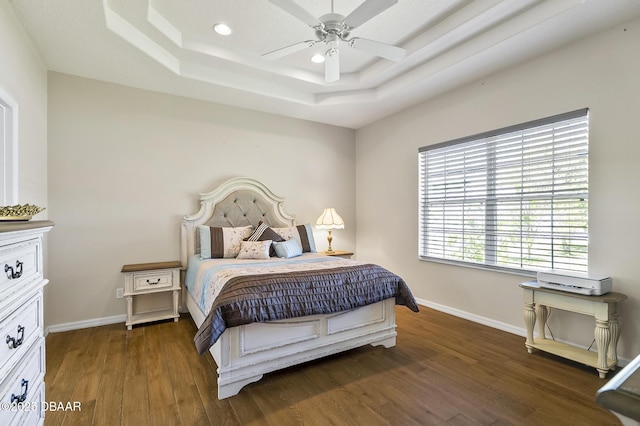 73 Foxhall Ln, Palm Coast, FL 32137 - bedroom with wood finished floors, a raised ceiling, baseboards, recessed lighting, and a ceiling fan