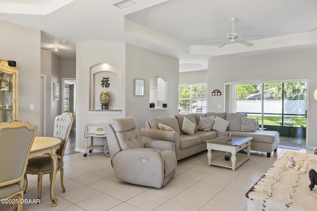 73 Foxhall Ln, Palm Coast, FL 32137 - living room with light tile patterned floors, a ceiling fan, and a raised ceiling