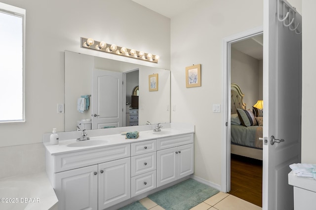 73 Foxhall Ln, Palm Coast, FL 32137 - ensuite bathroom with double vanity, tile patterned flooring, and a tub